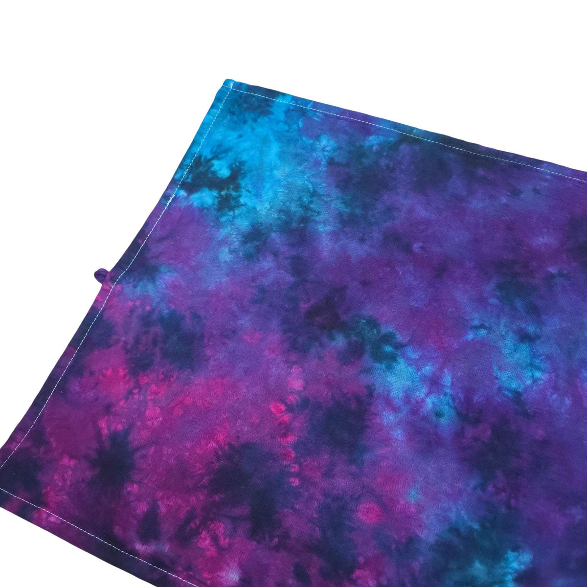 Nebula tie-dye tea towel corner view with hanging loop and purple-blue swirls
