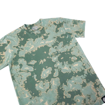Green bleach-dye camo T-shirt close-up showing crew neck and pattern
