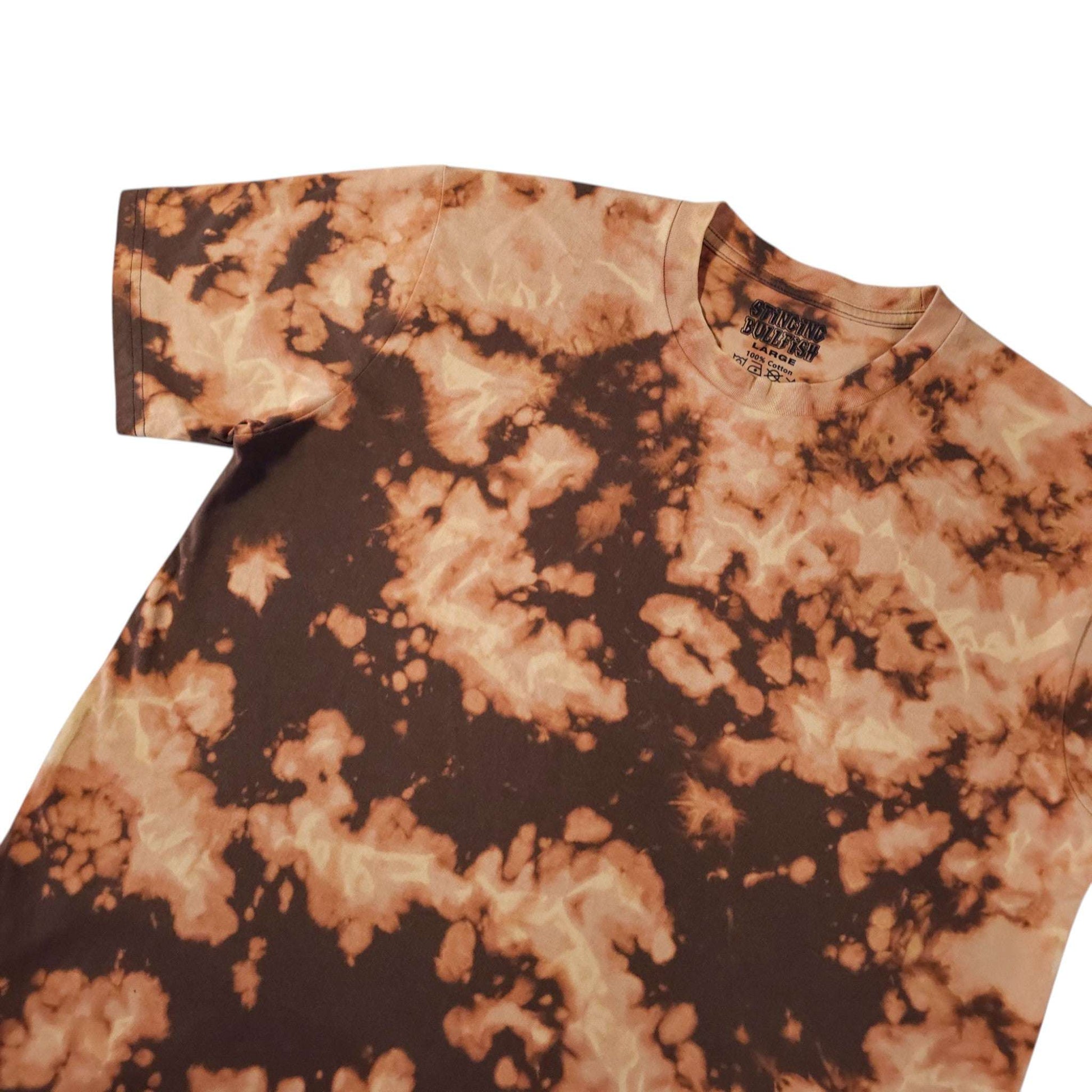 Tie-dye T-shirt with orange and dark brown splatter pattern, crew neck detail.