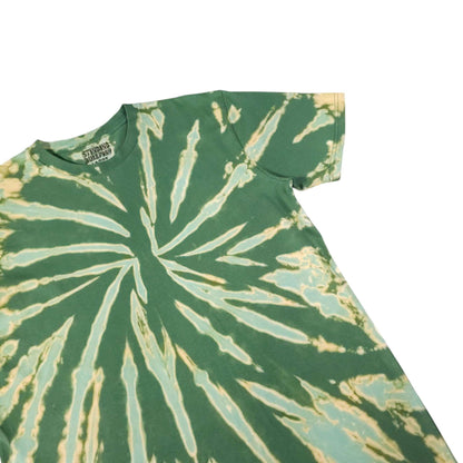 Close view of green crewneck T-shirt with off-white radial bleach-dye spiral burst.