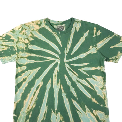 Green crewneck T-shirt with off-white radial bleach-dye lines forming a spiral burst.