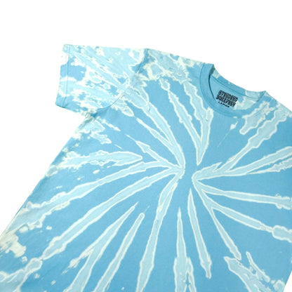Light blue bleach-dye T-shirt with white radial swirl, crew neck.