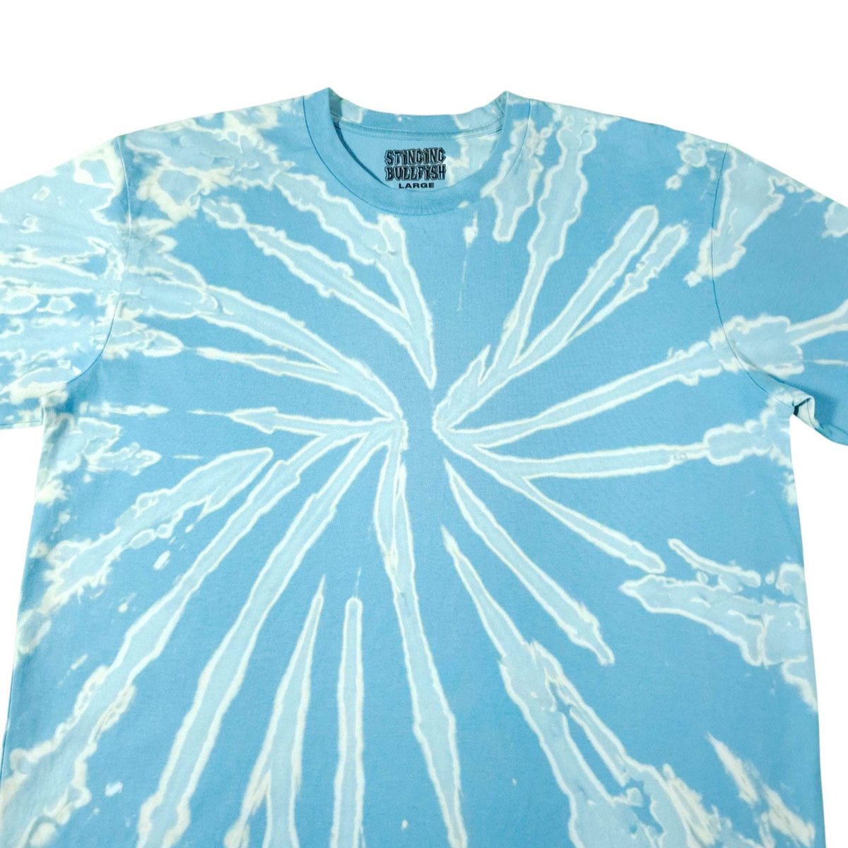 Light blue bleach-dye T-shirt showing white radial sunburst swirl detail.