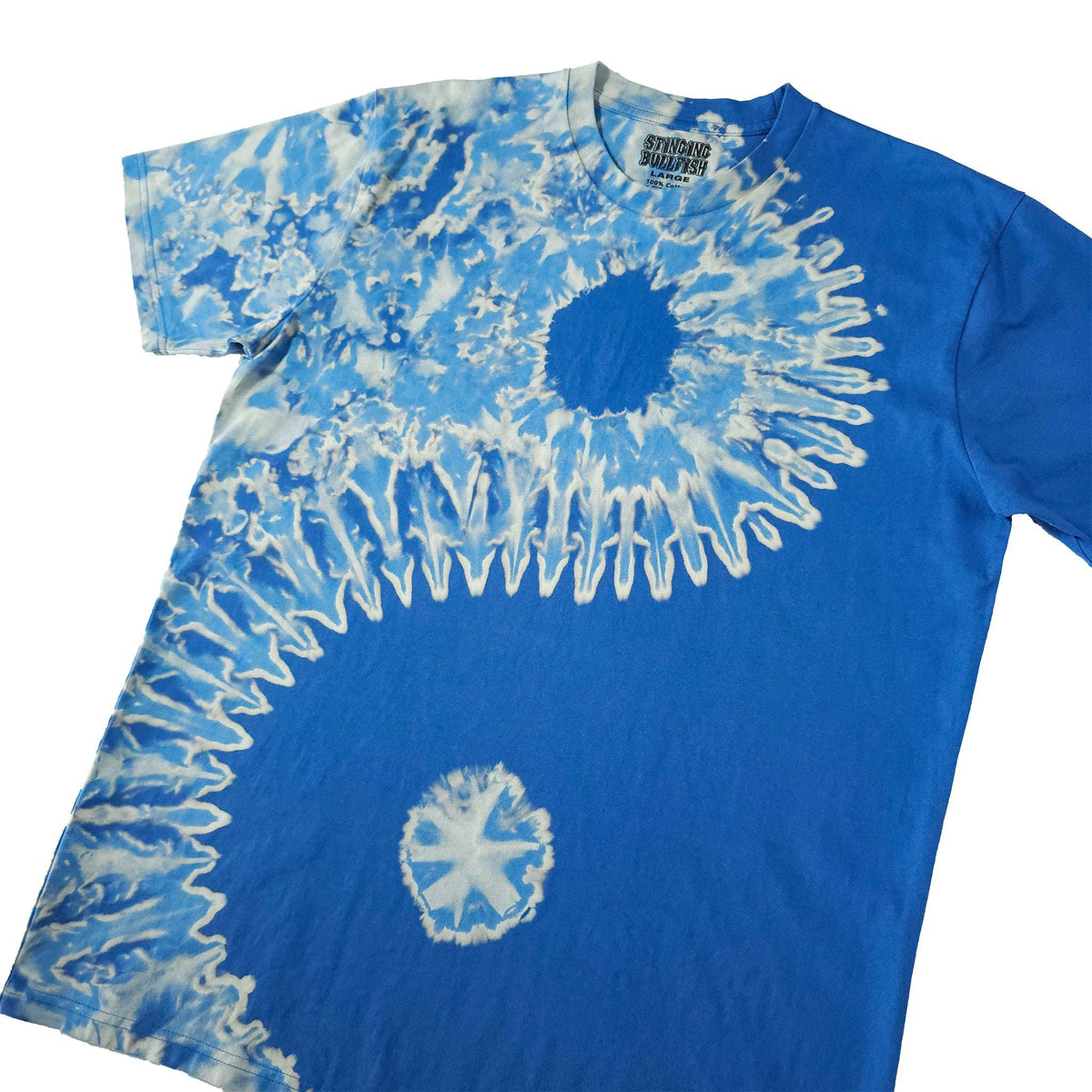 Blue bleach-dye T-shirt with bright white radial burst and dark circular accent print