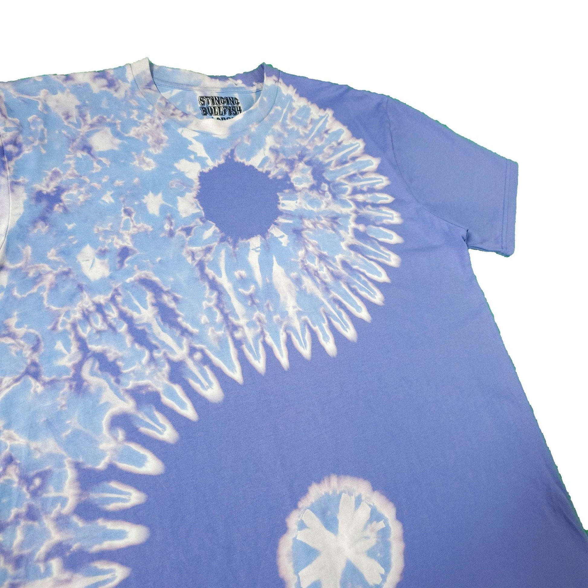 Blue bleach-dye T-shirt with circular spiral graphic and crew neck detail.