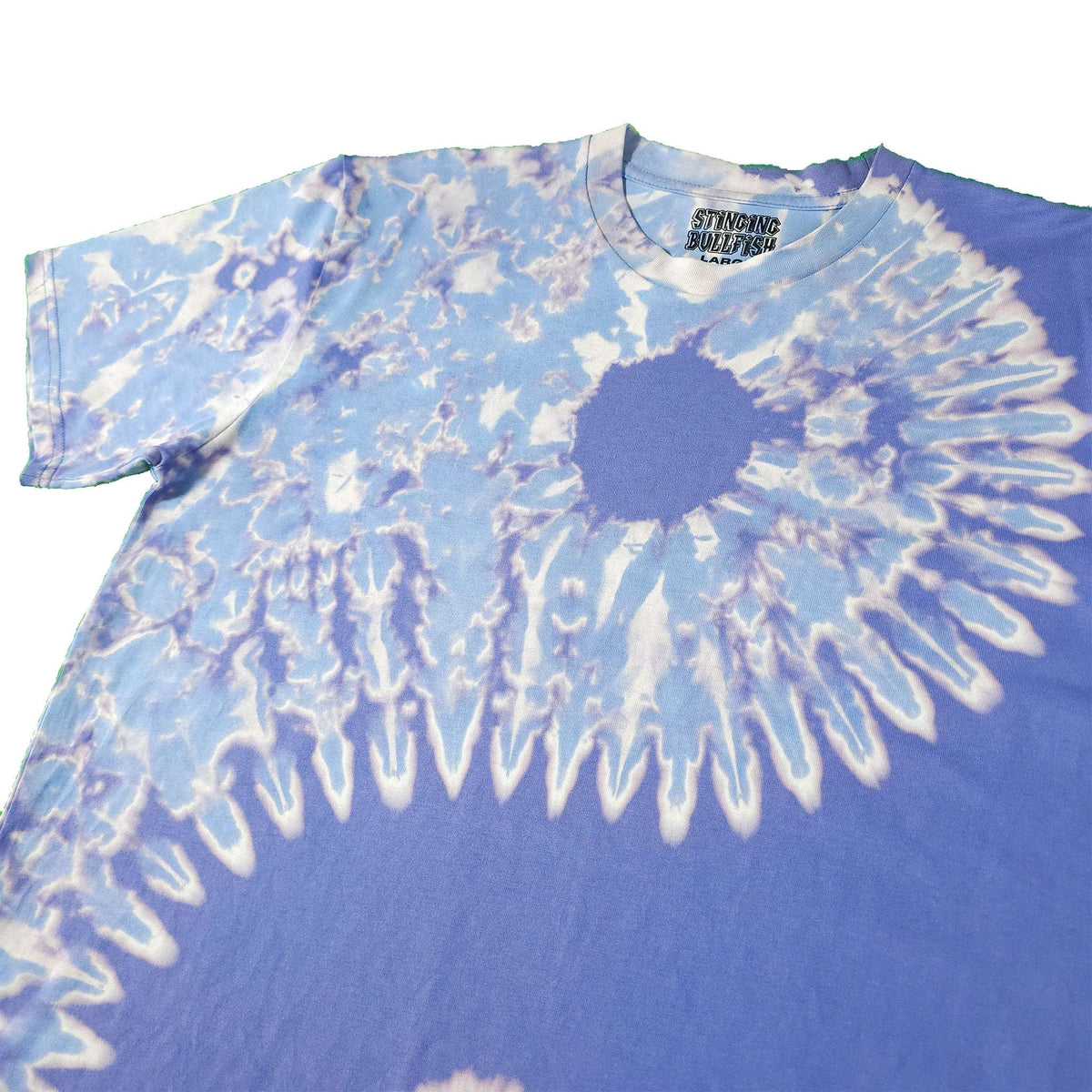 Blue bleach-dye T-shirt with large white spiral burst graphic and crew neck.