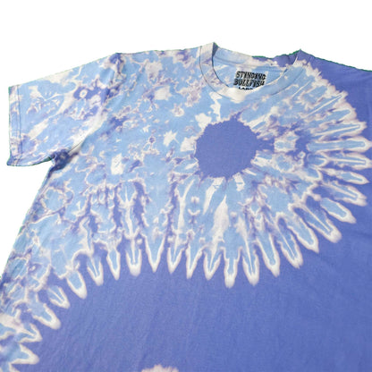 Blue bleach-dye T-shirt with large white spiral burst graphic and crew neck.