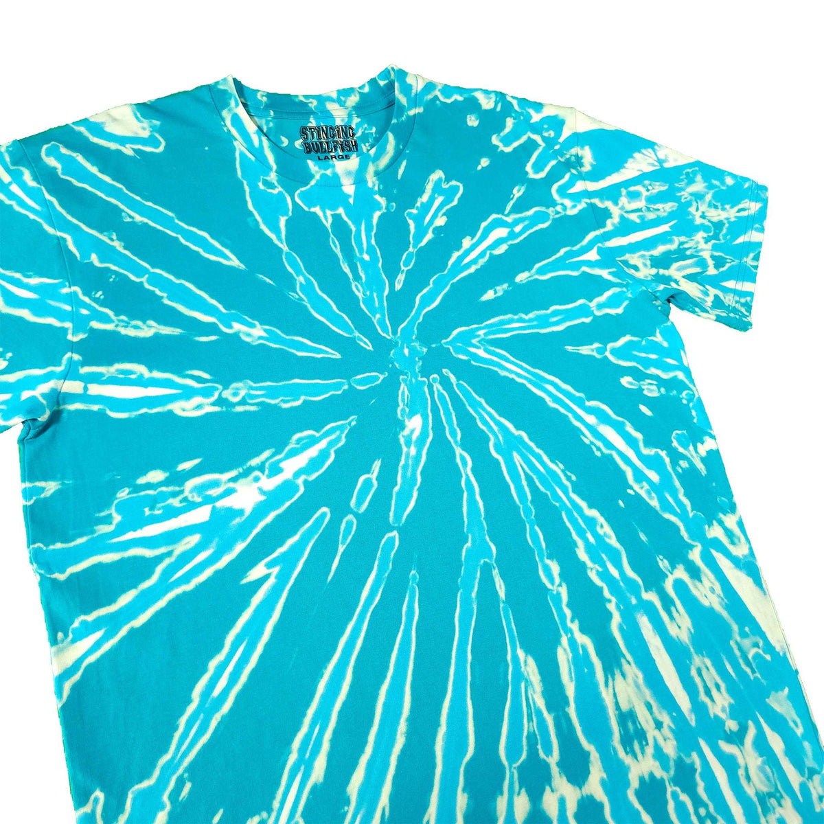 Teal tie-dye T-shirt with bold white starburst spiral, crew neck, short sleeves.