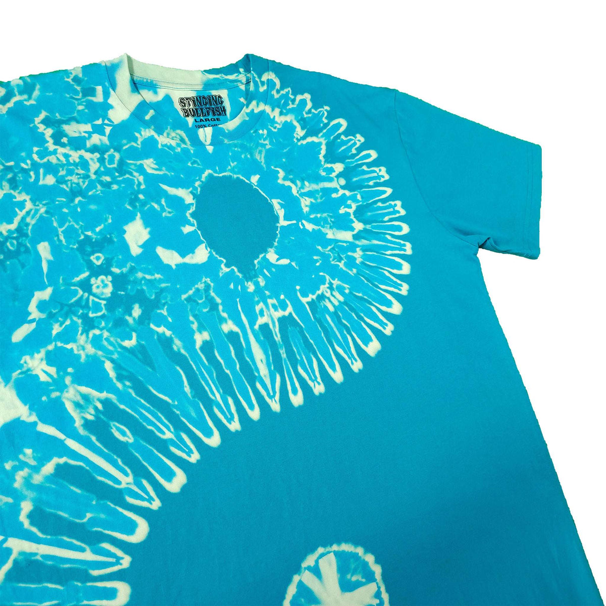 Teal tie-dye T-shirt close-up with white spiral sunburst graphic