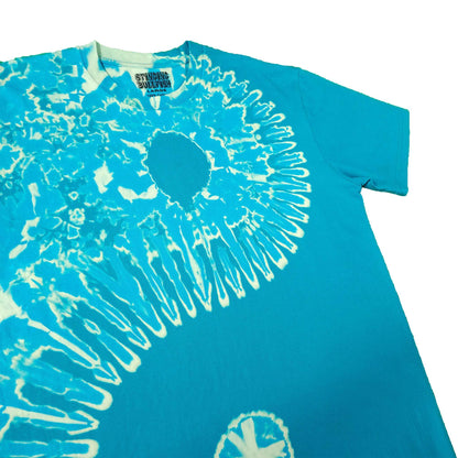 Teal tie-dye T-shirt close-up with white spiral sunburst graphic