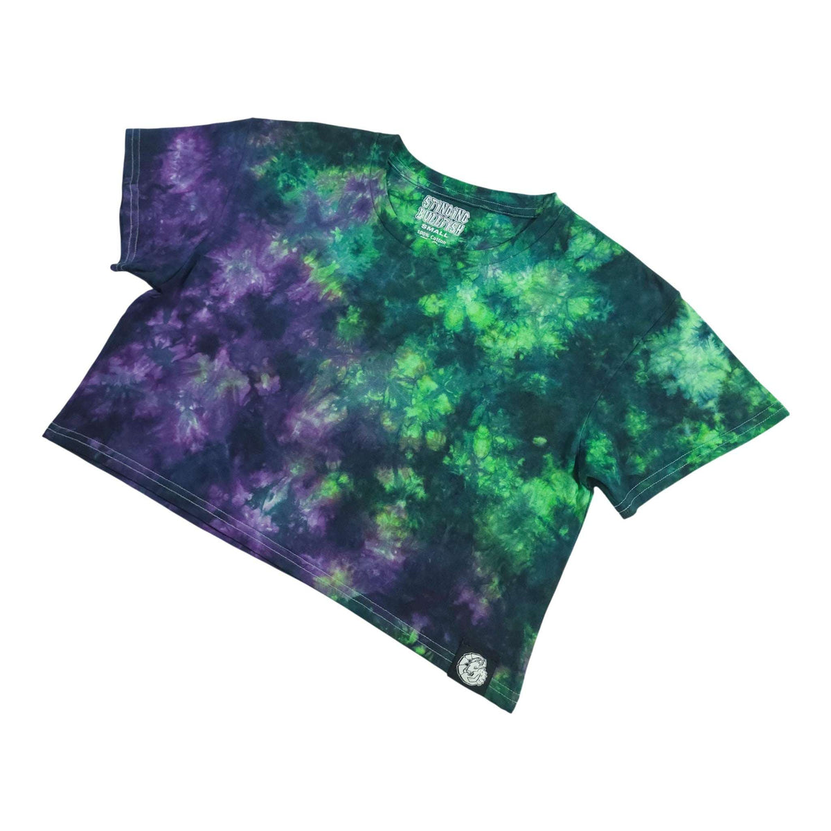 Tie-dye crop top angled view with purple and green swirl print and short sleeves