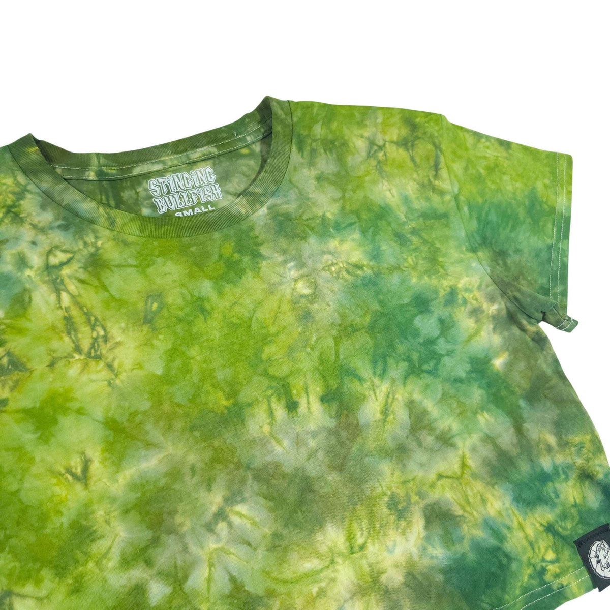 Green tie-dye crop top with short sleeves and crew neckline, side patch detail visible.