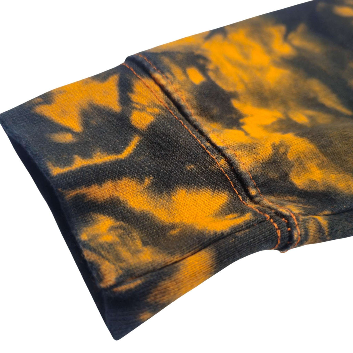 Tie-dye hoodie sleeve in black with bright orange swirls and stitched rib cuff