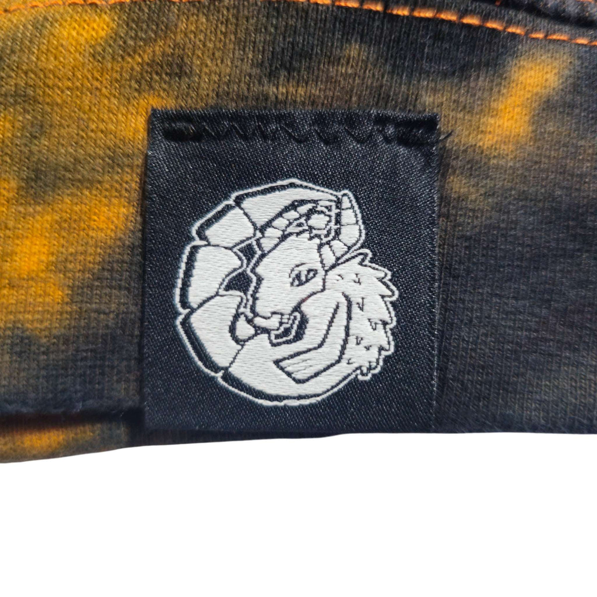 Woven logo patch on chest of black-and-orange tie-dye zip hoodie