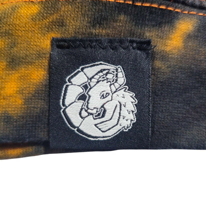 Woven logo patch on chest of black-and-orange tie-dye zip hoodie