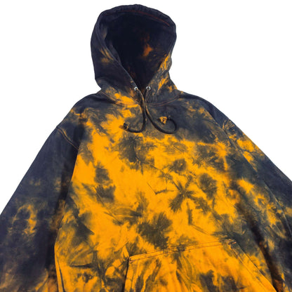 Kangaroo pocket and hood of black-and-orange tie-dye zip hoodie with drawstring cords