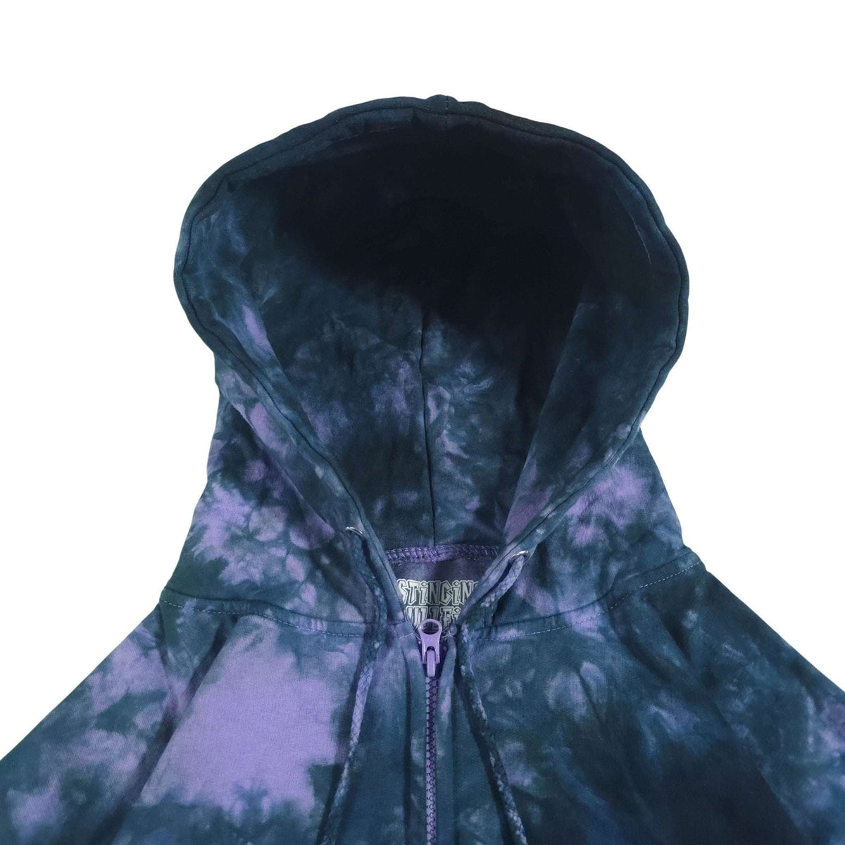 Tie-dye zip hoodie close-up: dark blue hood, purple-and-blue swirl print, drawstring.