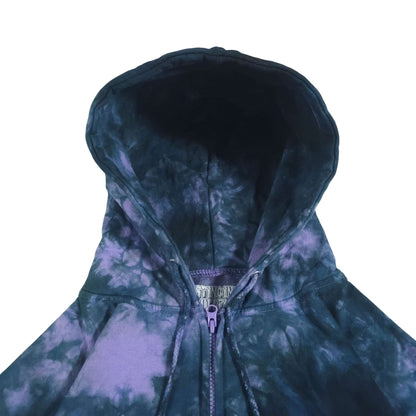 Tie-dye zip hoodie close-up: dark blue hood, purple-and-blue swirl print, drawstring.