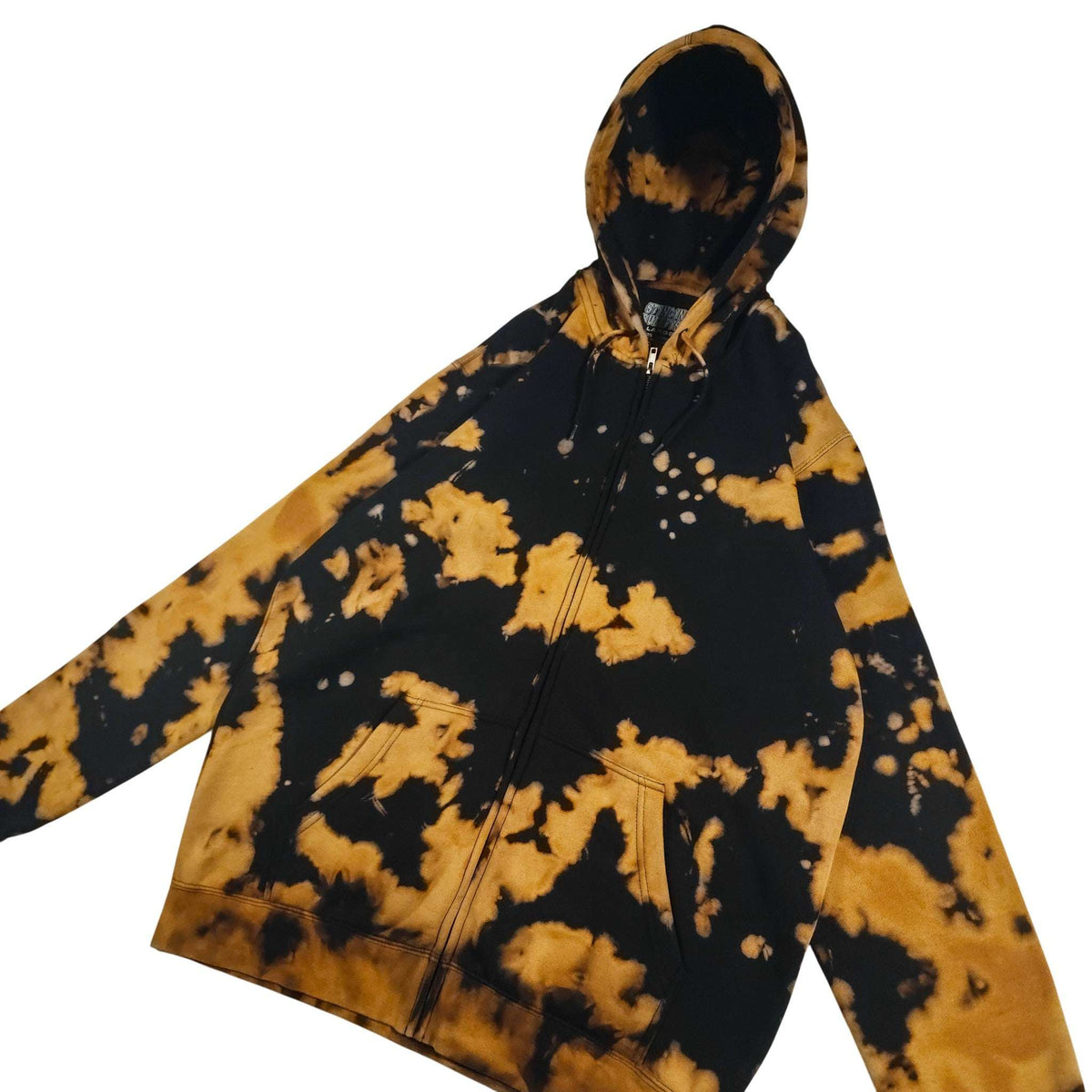 Black zip hoodie with tan/gold splatter print; long sleeves and front zipper