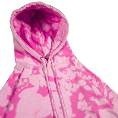 Pink bleach-dyed camo hoodie close-up showing hood lining and drawcord ends