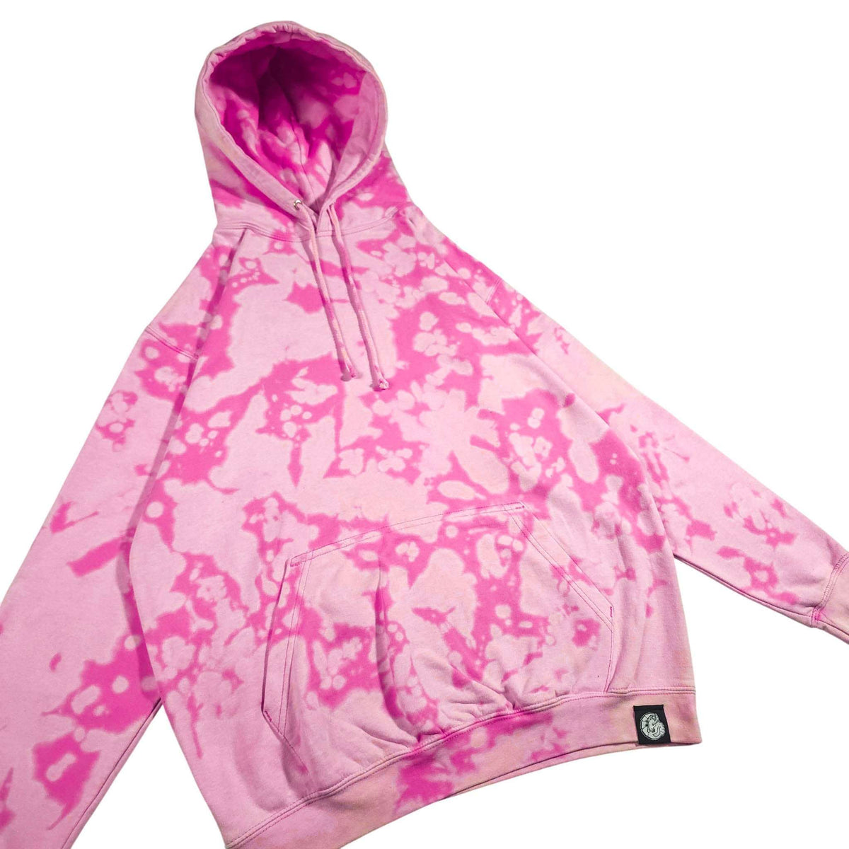 Pink bleach-dyed camo hoodie with hood, drawstrings, and front pouch pocket detail patch