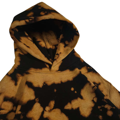 Relaxed tie-dye hoodie hood close-up, black and tan bleach camo splatter pattern