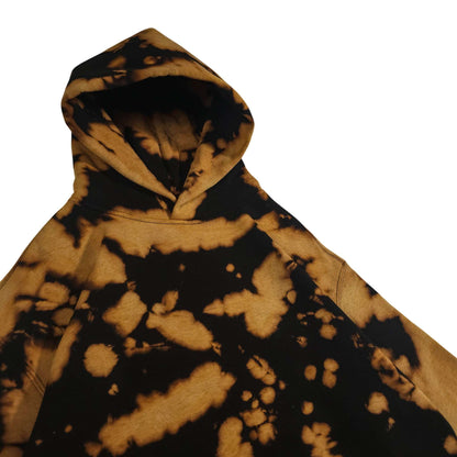 Relaxed tie-dye hoodie front close-up, black and tan bleach camo tie-dye pattern