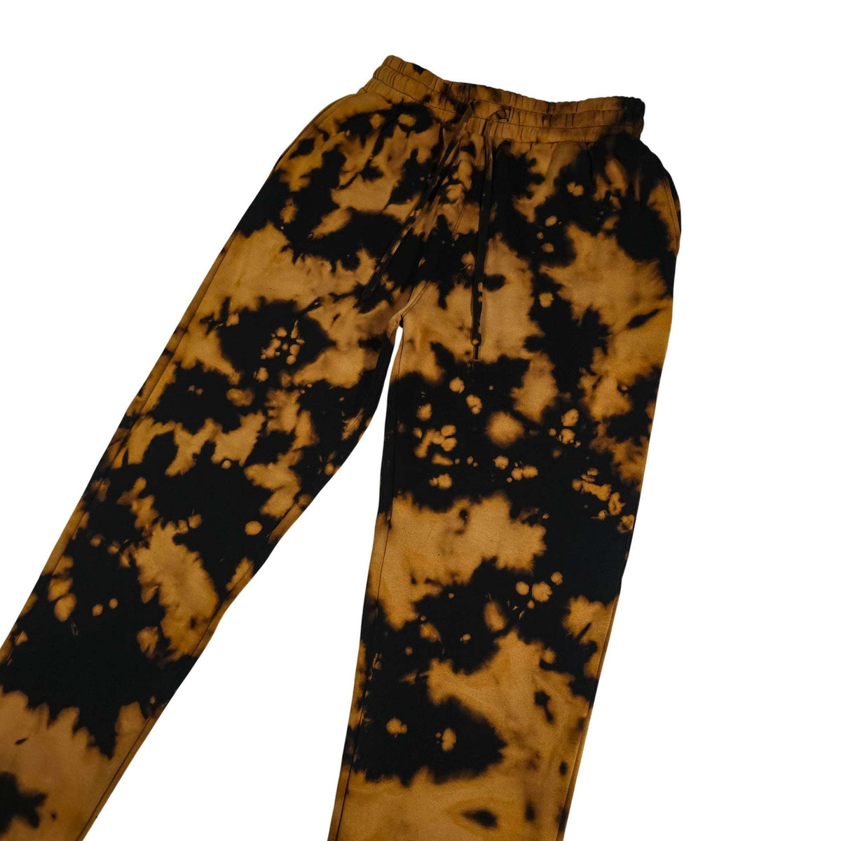 Cuffless tie-dye jogging pants with elastic waist and drawstring; bold black-and-tan blotches