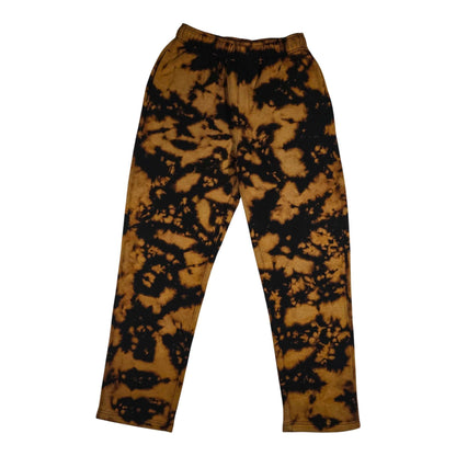 Tie-dye jogging bottoms with elastic waistband; black and tan splatter, cuffed hem.