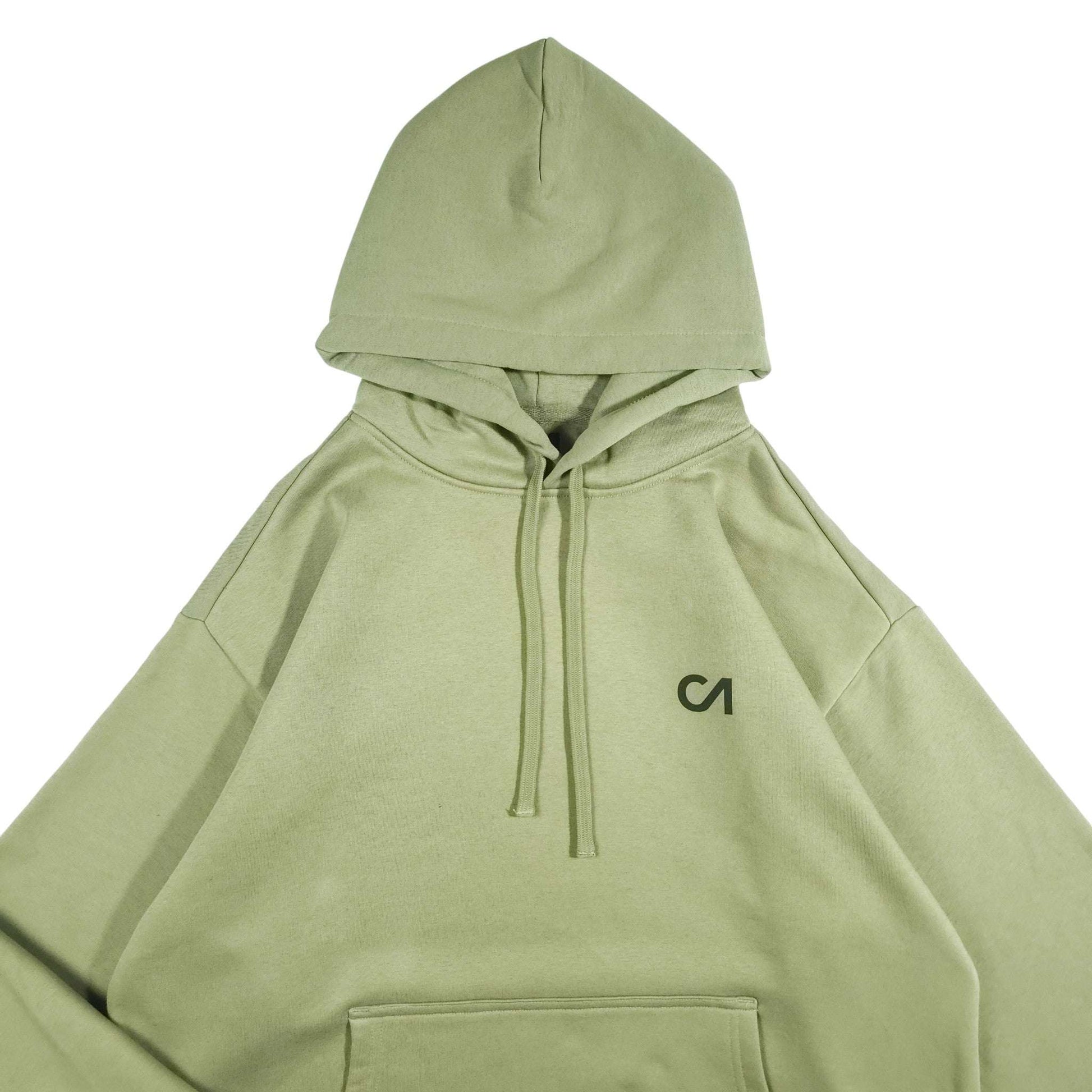 Light green pullover hoodie with drawstring hood and CA logo on chest