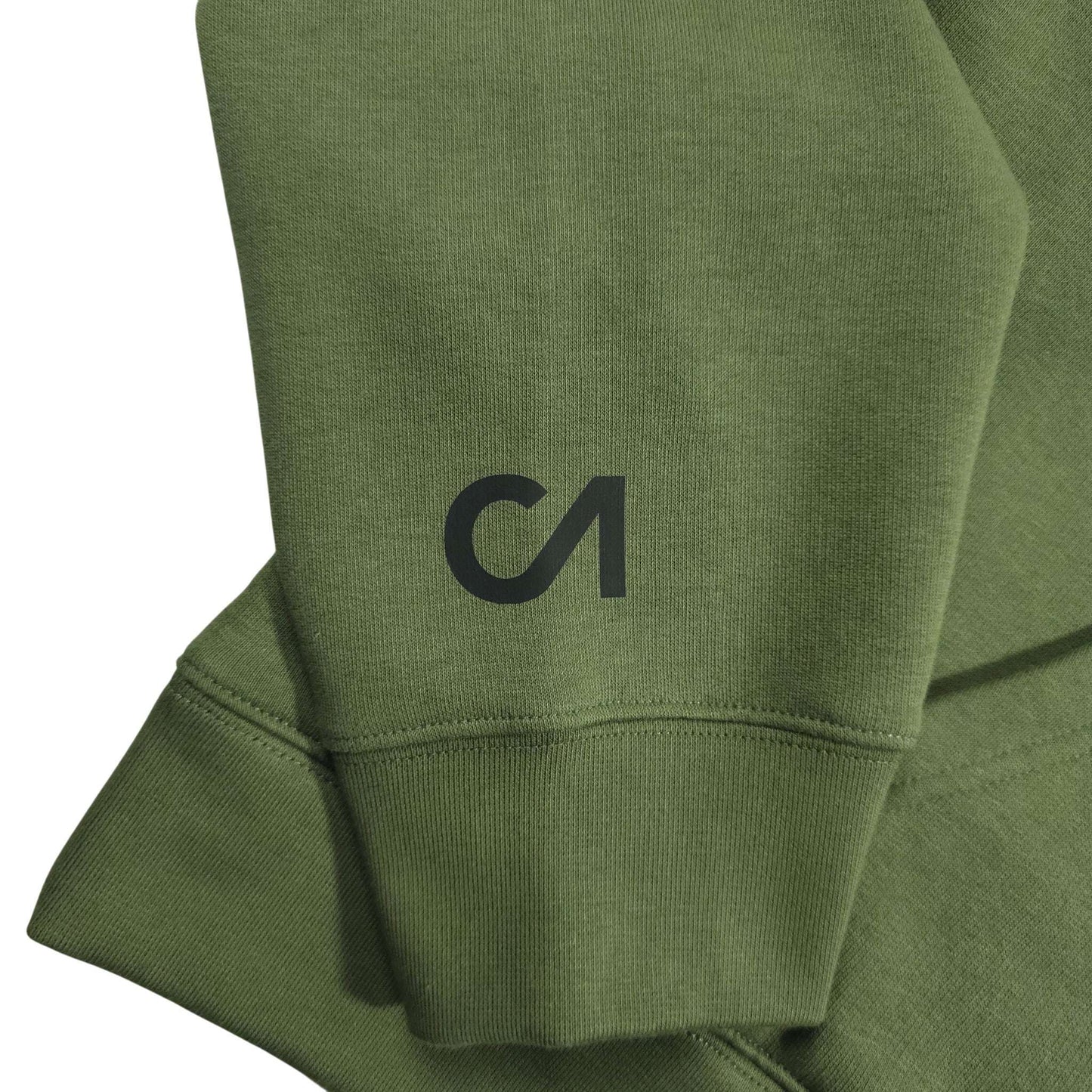 Green hoodie sleeve and cuff close-up with embroidered black logo