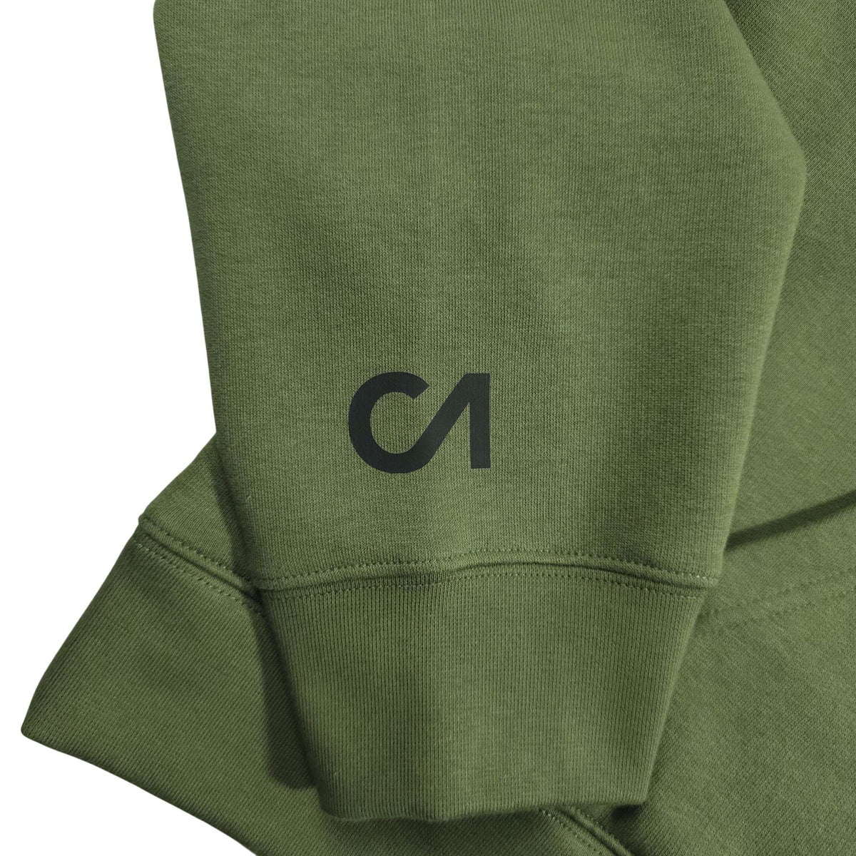 Green hoodie sleeve and cuff close-up with embroidered black logo