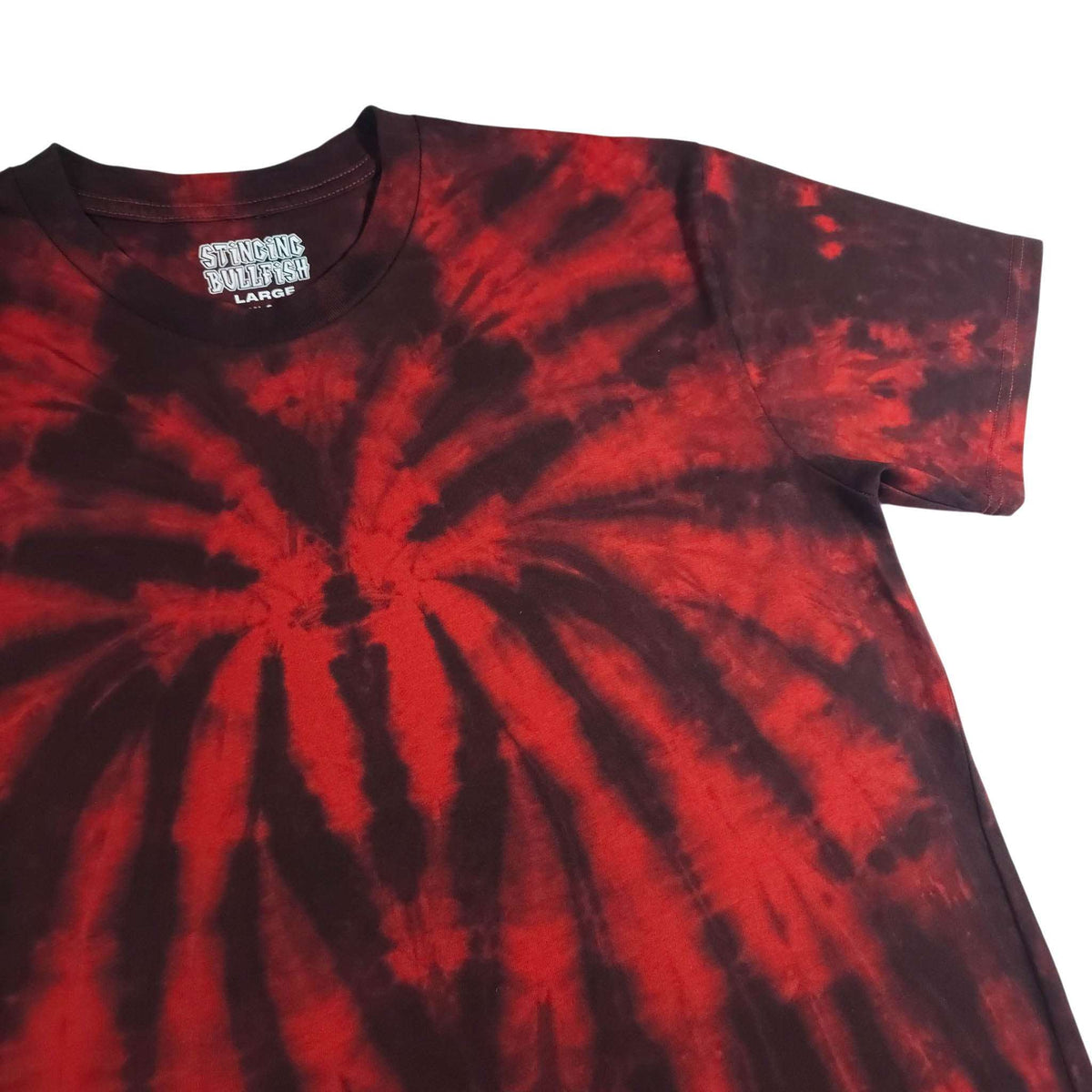 Spider tie-dye T-shirt side/front crop, red spiral rays on dark base, crew neck