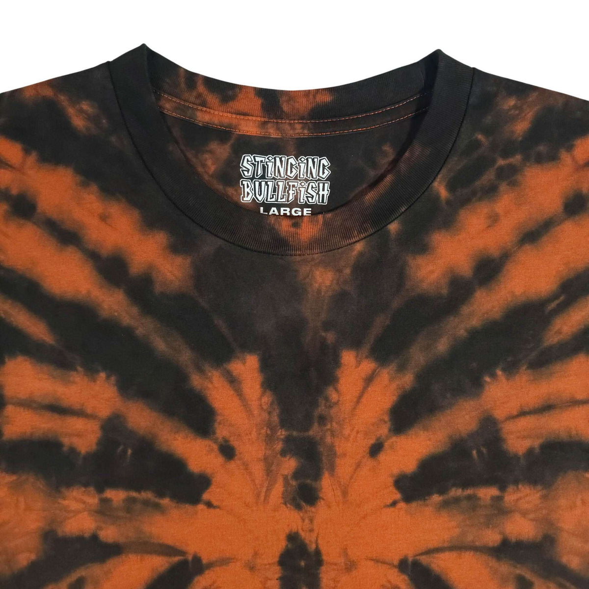 Men's V-neck tie-dye T-shirt close-up, burnt orange spiral with chest logo print