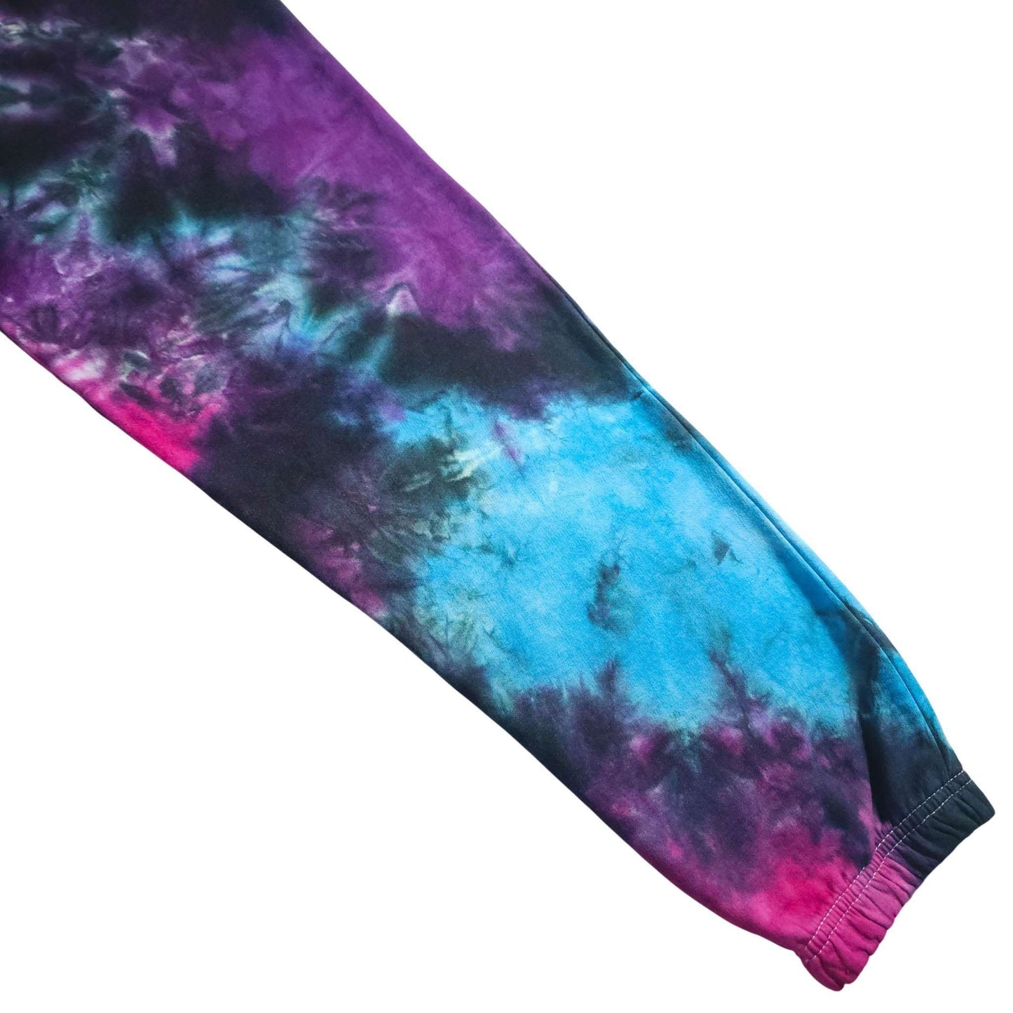 Tie-dye sleeve-style ankle cuff on joggers; purple and blue swirls with pink tones