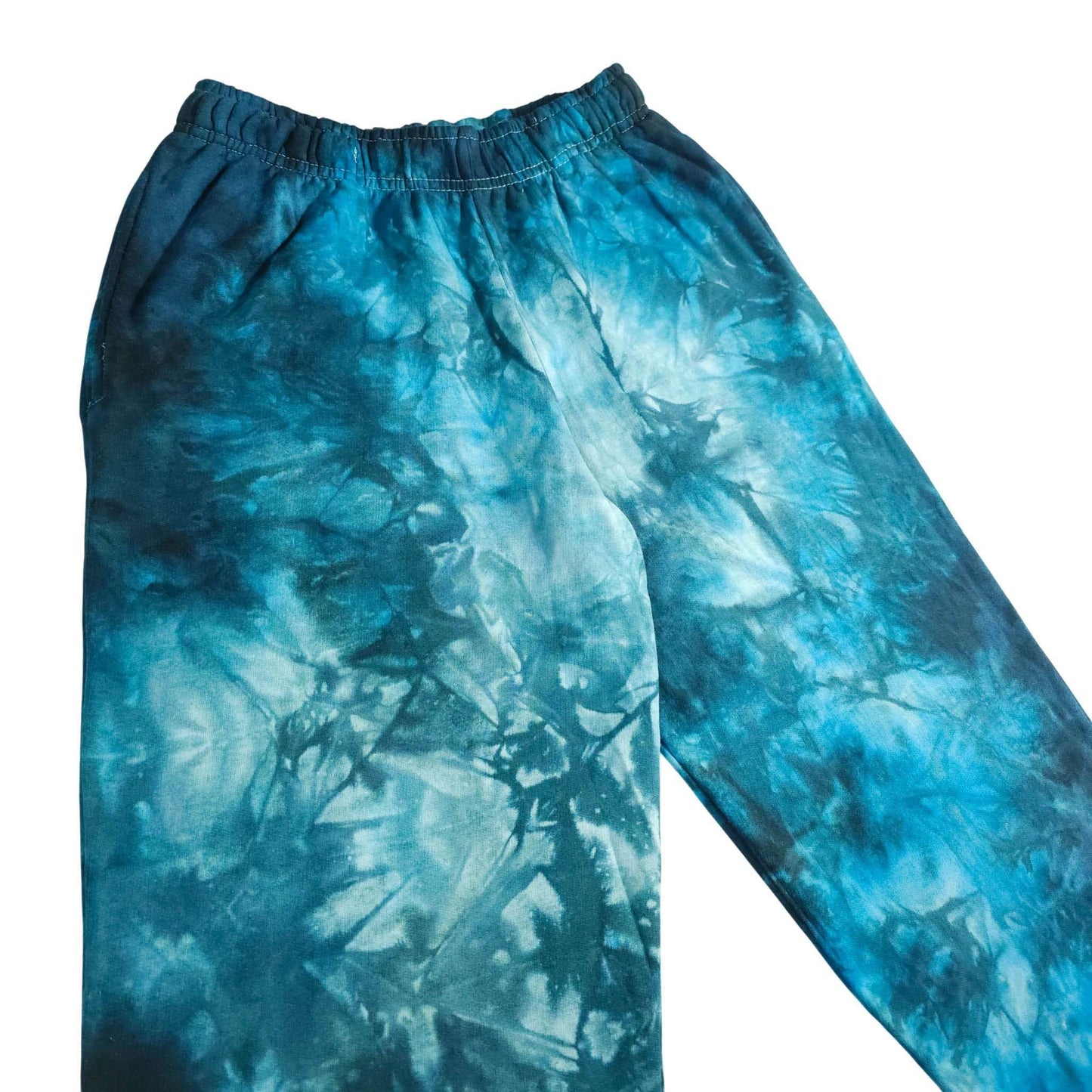 Blue tie-dye jogging bottoms, close-up of elastic waistband and relaxed leg
