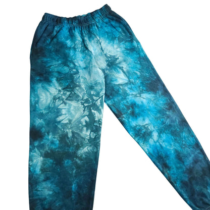Blue tie-dye jogging bottoms with elastic waistband and tapered relaxed fit