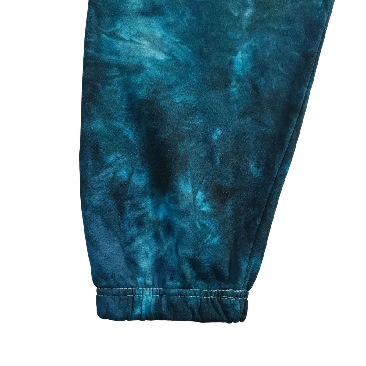 Blue tie-dye jogging bottoms with ribbed cuff at ankle and elastic waistband