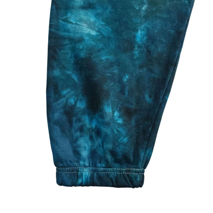 Blue tie-dye jogging bottoms with ribbed cuff at ankle and elastic waistband