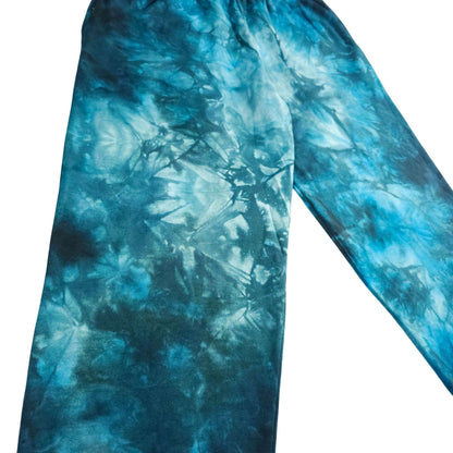 Blue tie-dye jogging bottoms detail view of fabric pattern and tapered leg