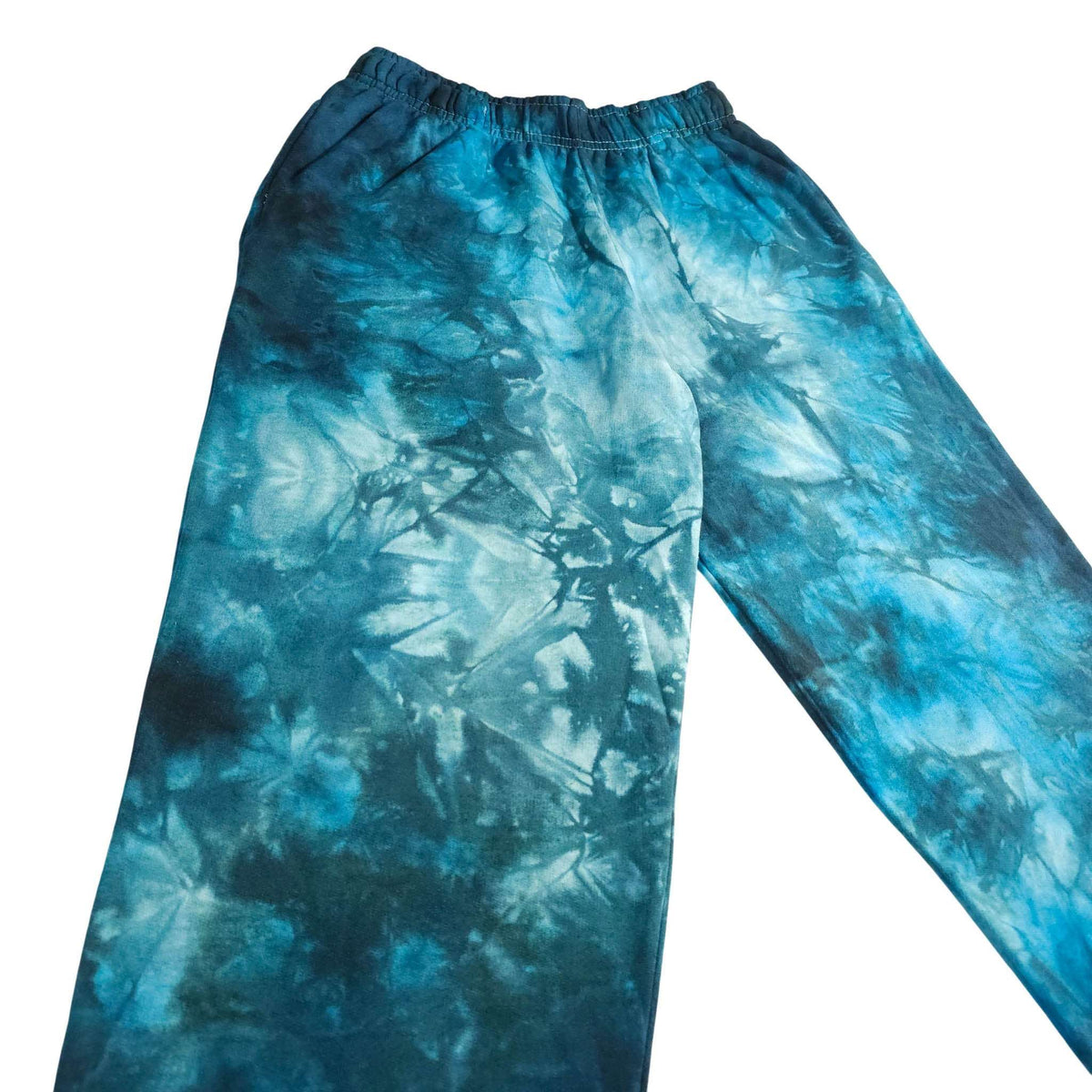 Blue tie-dye jogging bottoms, side view with elastic waistband and relaxed legs