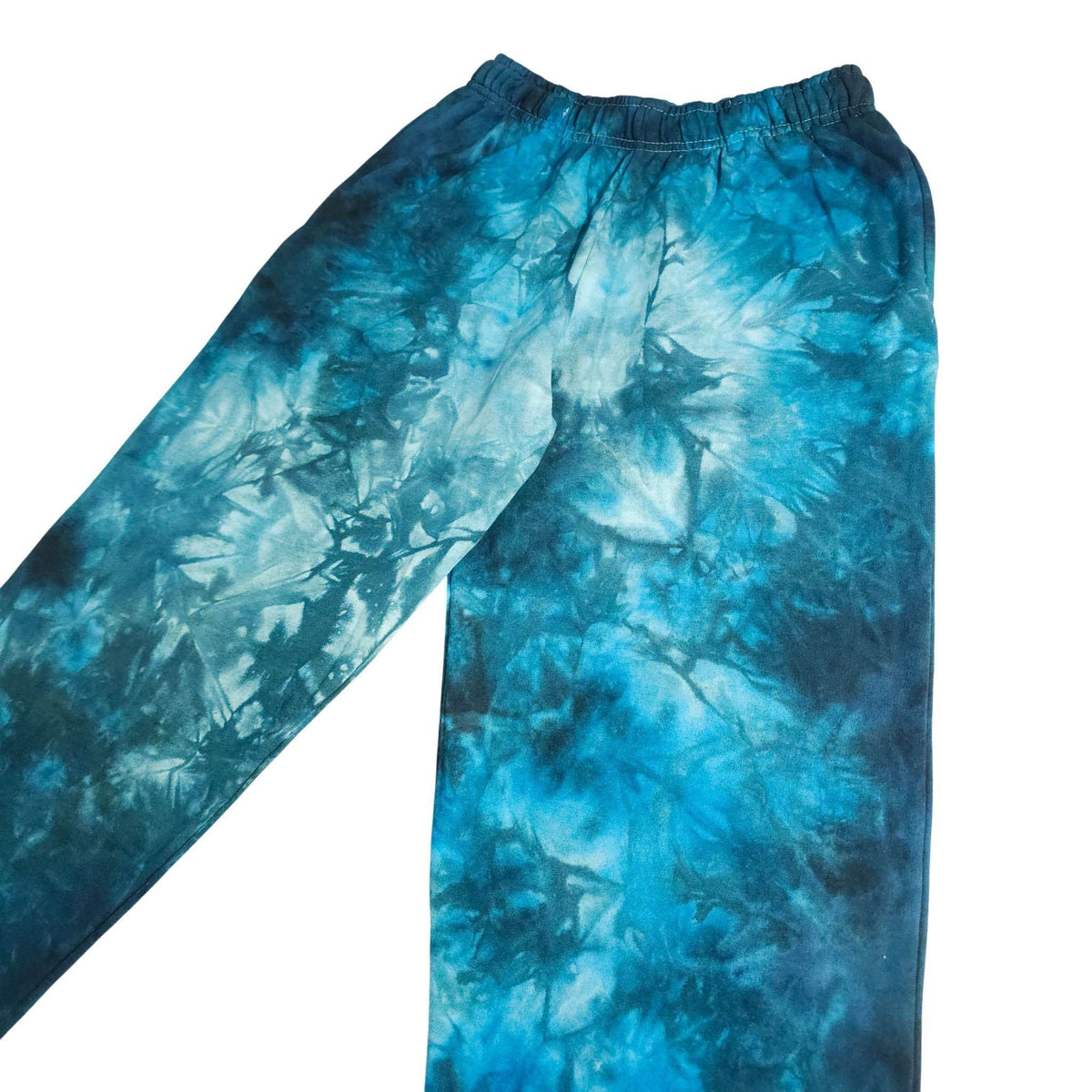 Blue tie-dye jogger pants detail view: elastic waistband and tapered leg, ribbed cuffs