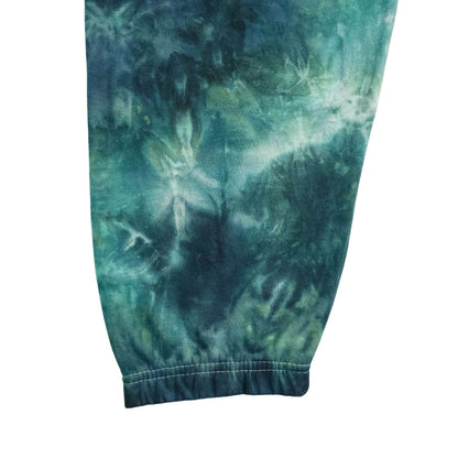 Teal and green tie-dye joggers showing ankle cuff and hem seam detail.