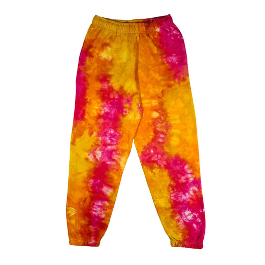 Tie-dye jogging bottoms with elastic waistband, tapered legs, yellow-orange and hot pink swirls.
