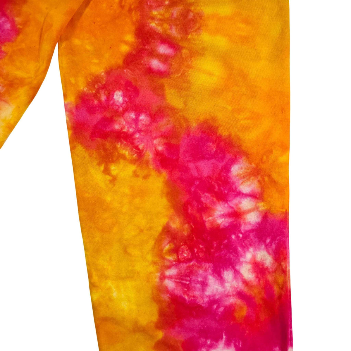 Close-up of orange and magenta tie-dye jogger fabric with seam detail