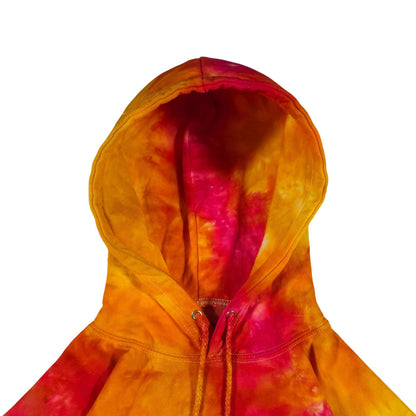 Tie-dye hoodie hood close-up with drawstring cords, orange and magenta
