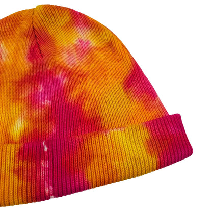 Tie-dye knit beanie hat with ribbed cuff and multicolor pattern