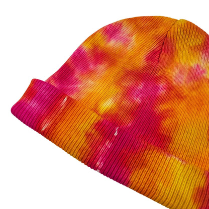 Tie-dye knit beanie hat with ribbed brim in orange and magenta