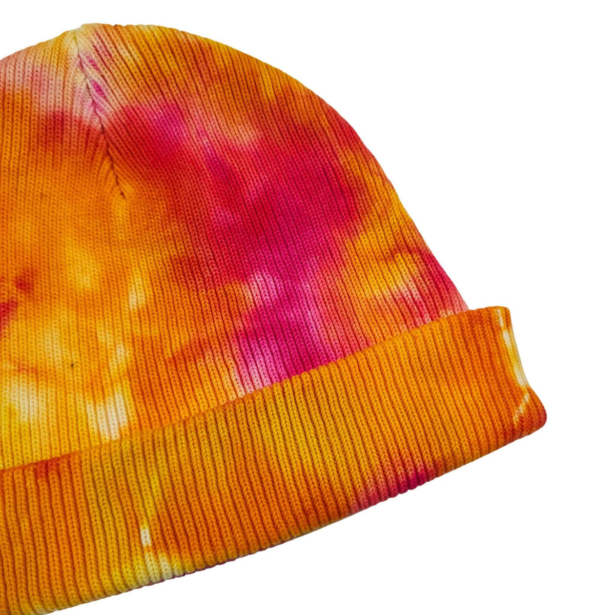 Tie-dye knit beanie hat showing knit texture and ribbed cuff detail