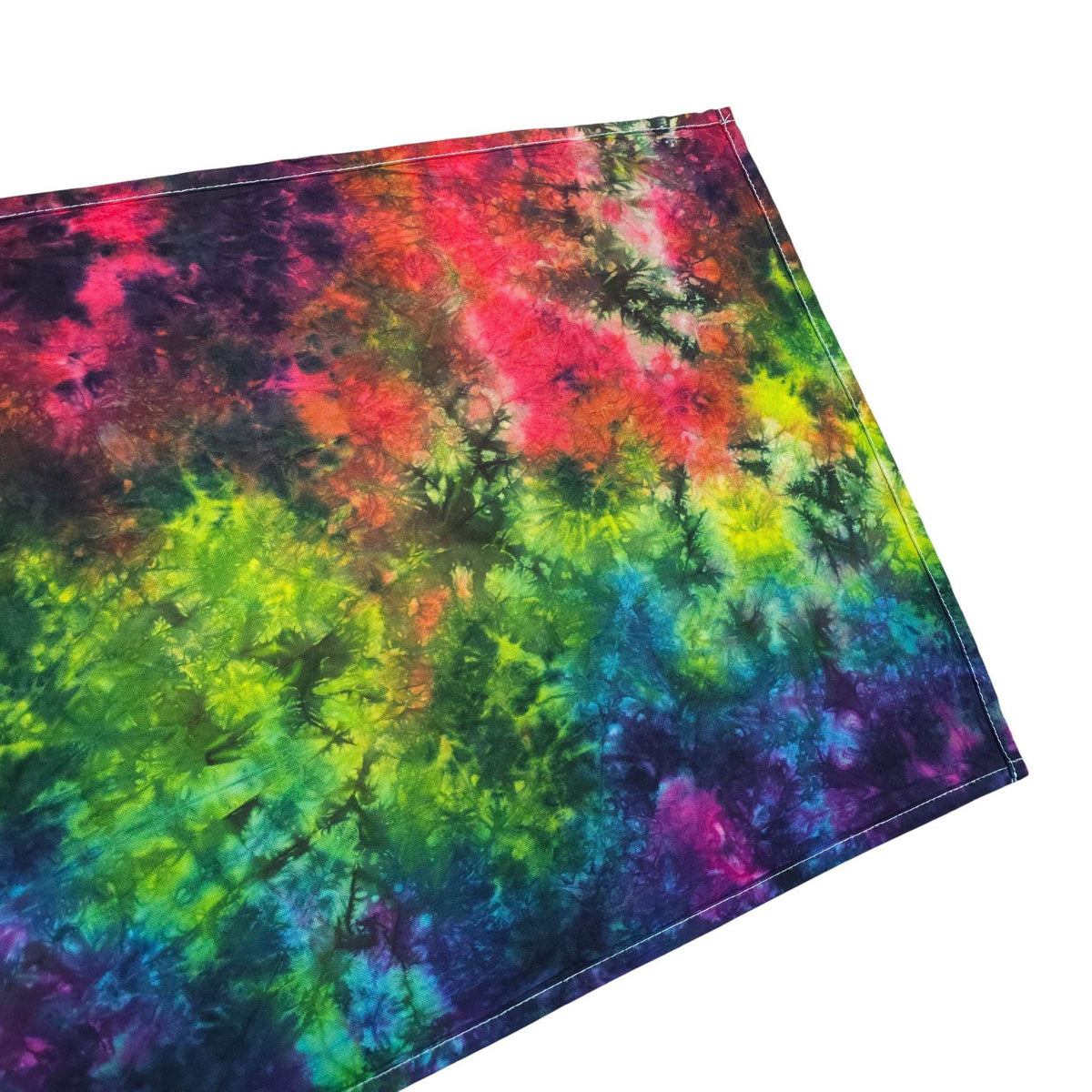 Folded rainbow tie-dye tea towel in bright green, magenta, blue; squared hem